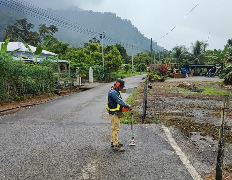 Technician using leak detection equipment